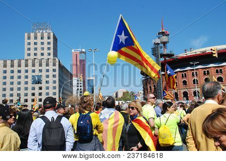 BARCELONA, SPAIN - APRIL 15, 2018: Catalans take part in the Llibertat Presos Politics (free political prisoners) protest march at Placa Espanya in support of jailed Catalan politicians.