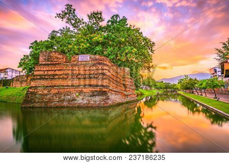 Chiang Mai, Thailand old city ancient wall and moat at dusk.