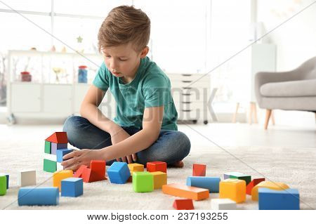Little Autistic Boy Playing With Cubes At Home