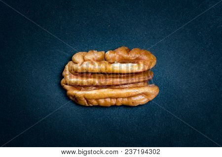 Pecan Nut On Dark Background With Highlighting Effect