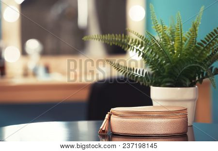 Cosmetic Bag And Plant On Table In Makeup Room