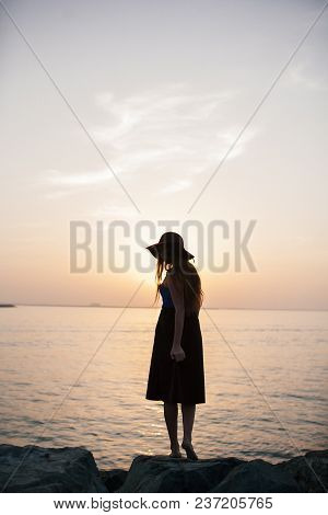 Beautiful Girl On A Sunset Background On A Sandy Beach. Woman.