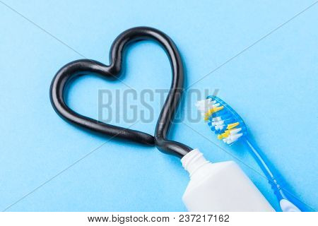 Black Toothpaste From Charcoal For White Teeth. Tooth-paste In The Form Of Heart, Tube And Toothbrus
