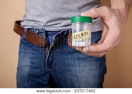 Sample Of Sperm For Analysis Of Infertility. Man Is Holding A Jar Of Tests In His Hands. Concept Of 