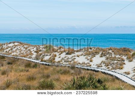 Wooden Walking Path Over Sand Beach And Ocean Skyline Natural Landscape Background