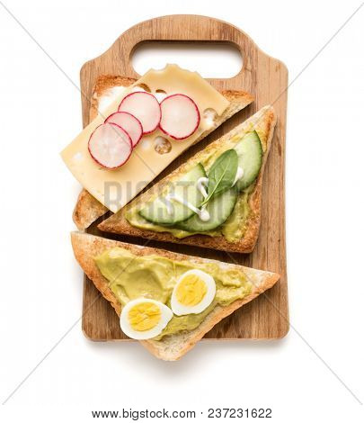 Open  faced vegetable sandwich canape or crostini on a wooden serving board  isolated on white background closeup. Top view.  Vegetarian tartarine.
