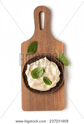 Open  faced hummus sandwich canape or crostini on a wooden serving board  isolated on white background closeup. Top view. Vegetarian tartarine.