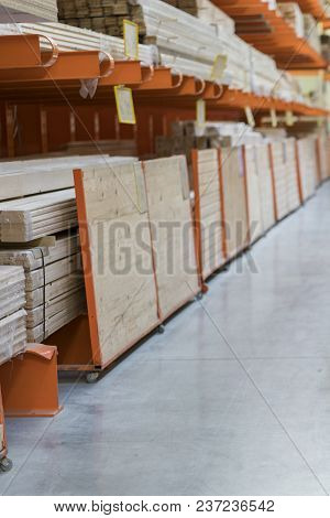 Wood Stacked On Shelving Inside A Lumber Yard.