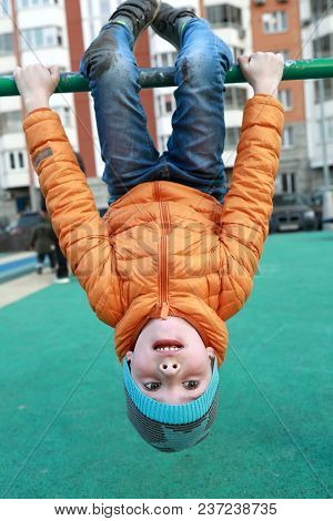 Boy On Horizontal Bar At Outdoor Playground