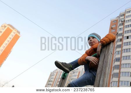 Kid On Horizontal Bar At Outdoor Playground