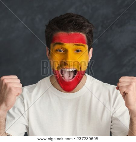 Face Of Young Screaming Man Painted With Flag Of Spain. Football Or Soccer Team Fan, Sport Event, Fa