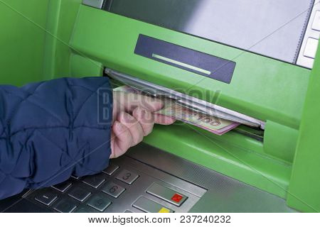 Photo Of The Hand Taking From Atm Ukrainian Hryvnas