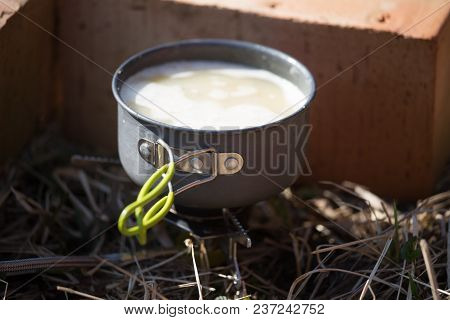 A Closeup Of A Boiling Pot On A Gas Primus Cooking Dinner For Hikers. Outdoors Kitchen.
