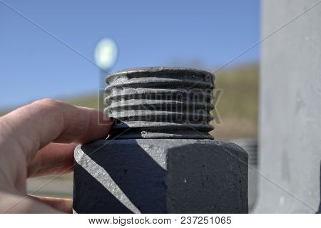 Technology,engineering,modernity And Construction Progress Concept: Large Metal Screw Securing A Hig