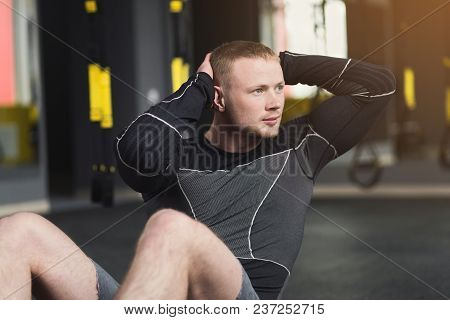 Young Man Workout In Fitness Club. Portrait Of Caucasian Guy Making Exercise, Sit-ups And Crunches F