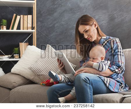 Happy Beautiful Business Mom Using Digital Tablet While Spending Time With Her Cute Baby. Business, 