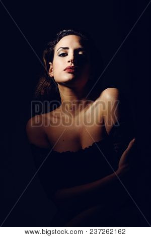 Young Brunette Woman In Black Lingerie In Chiaroscuro Lighting