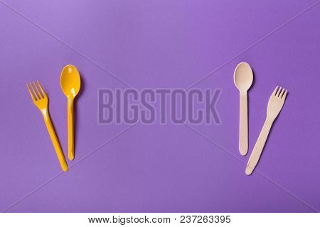 Organic Bamboo Disposable Cutlery Vs Plastic Ones On Purple Background. Environmentally Friendly Woo
