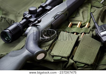 Modern hunting rifle with optical sight and equipment.