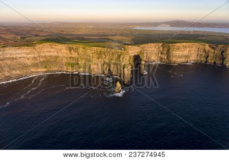Beautiful Scenic Aerial Drone View Of Ireland Cliffs Of Moher In County Clare. Sunset Over The Cliff