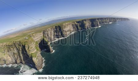 Beautiful Scenic Aerial Drone View Of Ireland Cliffs Of Moher In County Clare. Sunset Over The Cliff