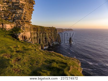 Beautiful Scenic Aerial Drone View Of Ireland Cliffs Of Moher In County Clare. Sunset Over The Cliff