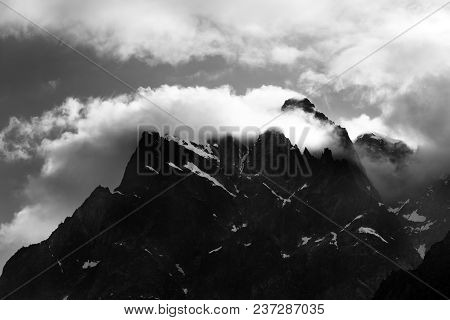 Black And White Rocks With Snow In Clouds. Caucasus Mountains, Georgia, Region Svaneti.