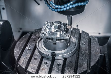 Metalworking CNC milling machine. Cutting metal modern processing technology. Small depth of field. Warning - authentic shooting in challenging conditions. A little bit grain and maybe blurred.