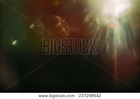 Lens Flare. Colorful Abstract. Bokeh Light On Black Background. Ray Leak