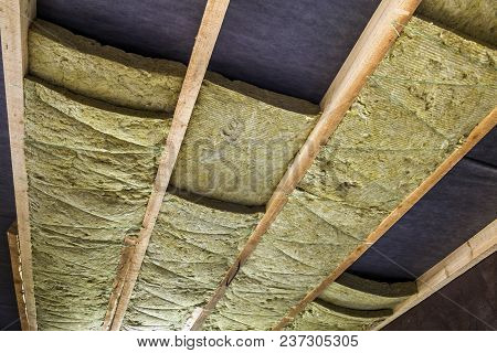 Thermal Insulation Mineral Rock Wool Installation At The New Building Attic Ceiling
