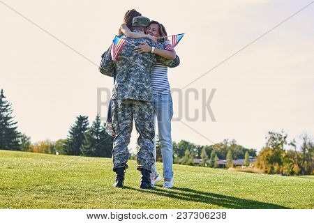 Military Man Father Hugs Daugther And Wife. Portrait Of Happy American Family With Father Us Soldier
