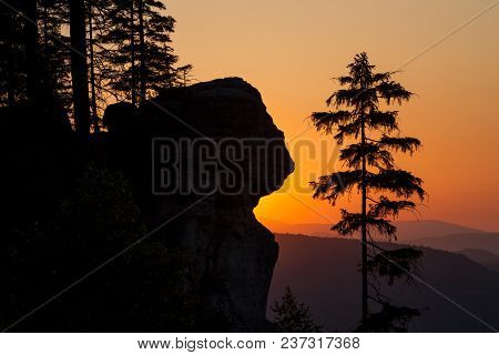 A Silhouetted Sandstone Cliff And Trees At Sunset On Ostas Hill In Northern Czech Republic