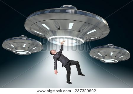 Man Being Abducted By Ufo - Concept Of Alien Abduction