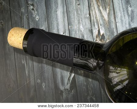 Bottle Of Wine With Natural Cork On A Dark Wooden Table