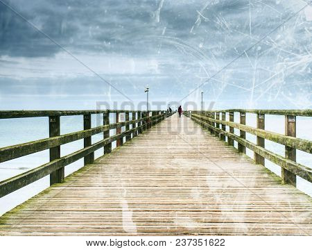 Abstract Effect.  Old Wood Beach Bridge In Goehren With Nobody. Autumnal Misty Weather With Cloudy S