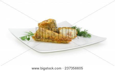 Slices Of The Fried Saltwater Fish Notothenia Decorated With Parsley And Dill Twigs On A Square Dish