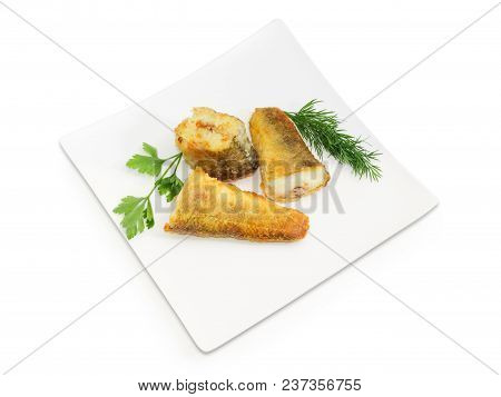 Three Slices Of The Fried Saltwater Fish Notothenia With Parsley And Dill Twigs On A Square Dish On 