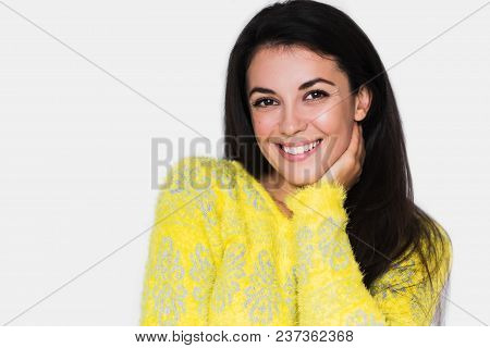 Portrait Of Brunette Cheerful Woman With Healthy Toothy Smile, Look In Front With Hands On Hair. You