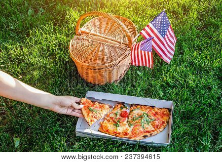 Celebrating Independence Day Of America In The Park With Pizza. Picknick Basket With Usa Flag.