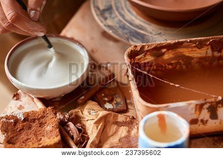 Red Clay Shavings On The Worktop Background, Top View, Close-up, Shallow Depth Of Field. Pottery Wor