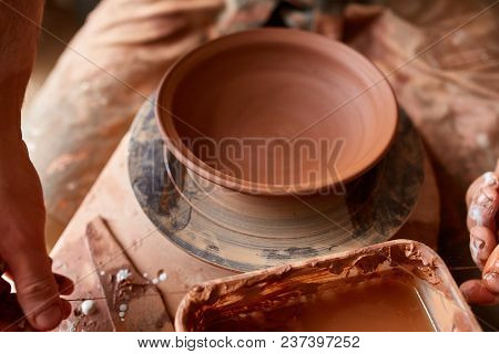 Making Pottery On A Potter's Wheel In The Workshop, Close-up, Selective Focus.