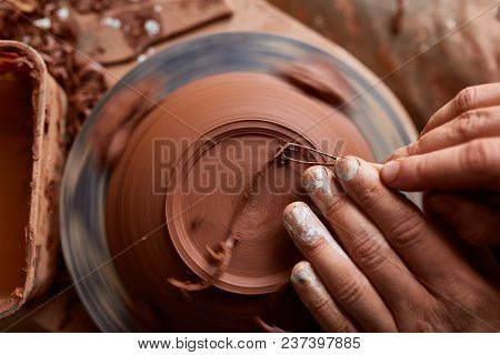 Close-up Hands Of A Male Potter In Plaid Shirt And Dirty Apron Who Molds A Vase From Clay, Selective