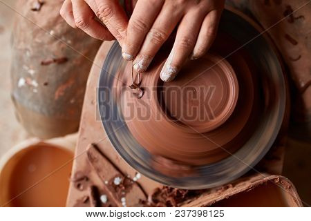 Close-up Hands Of A Male Potter In Plaid Shirt And Dirty Apron Who Molds A Vase From Clay, Selective