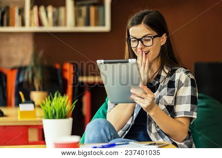 Happy Young Woman Enterpreneur Wears Eyeglasses And Stylish Shirt Work With Tablet Pc In Modern Offi