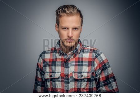 Studio Portrait Of Blond Bearded Male Dressed In A Red Plaid Shirt Isolated On Grey Vignette Backgro