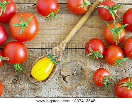 Fresh Red And Yellow Tomatoes On Wooden Background.