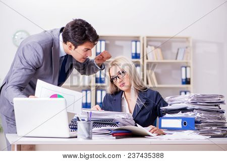 Angry irate boss yelling and shouting at his secretary employee