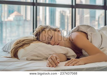 Woman Wakes Up In The Morning In An Apartment In The Downtown Area With A View Of The Skyscrapers. L