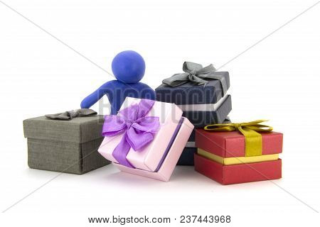 Blue Plasticine Character And Gift Boxes On White Background. Present Boxes. Holidays Concept.