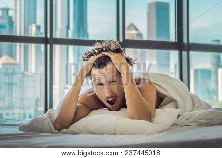 Man Wakes Up In The Morning In An Apartment In The Downtown Area With A View Of The Skyscrapers. Lif